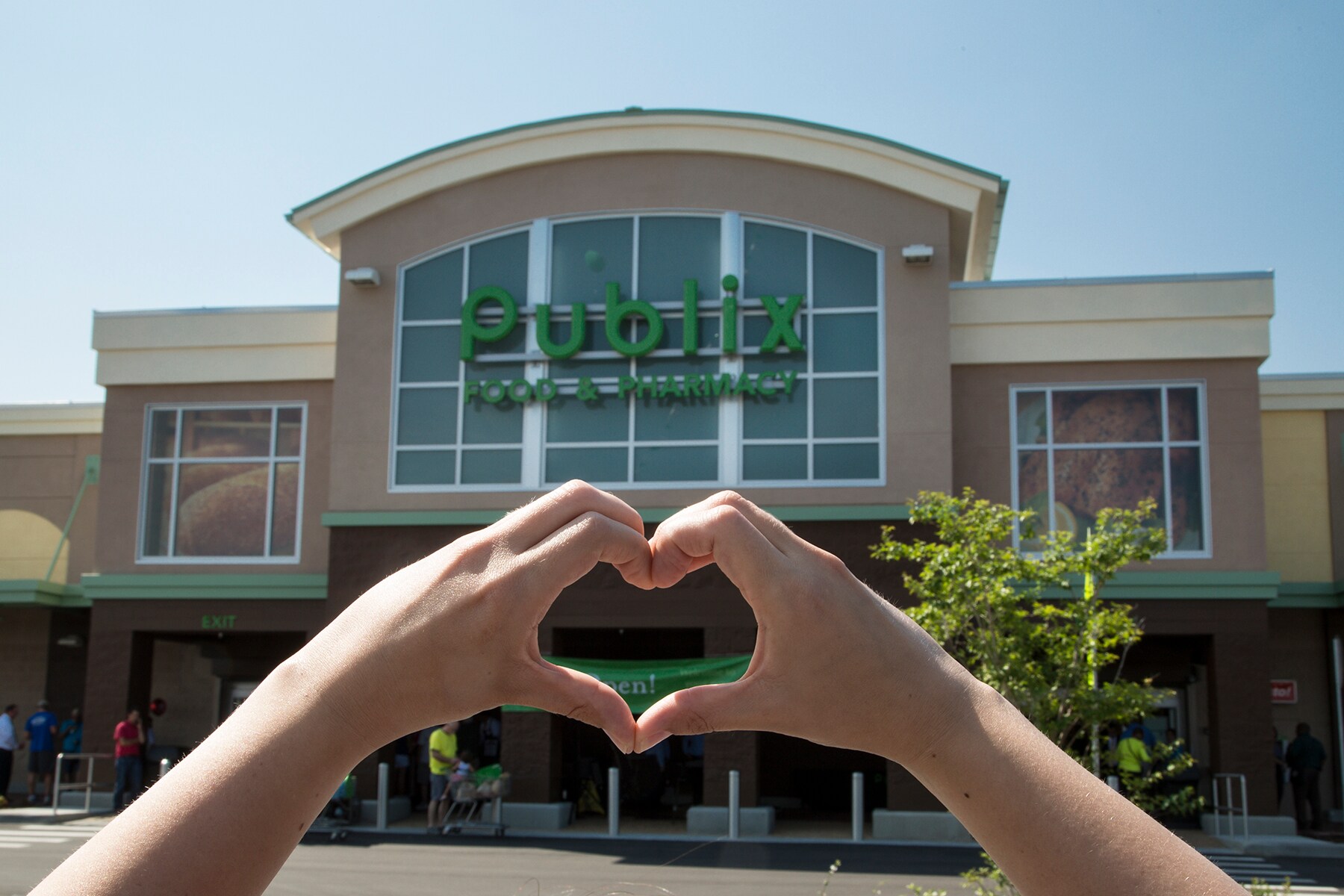 Hand heart in front of Publix store