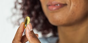 Woman holding a vitamin